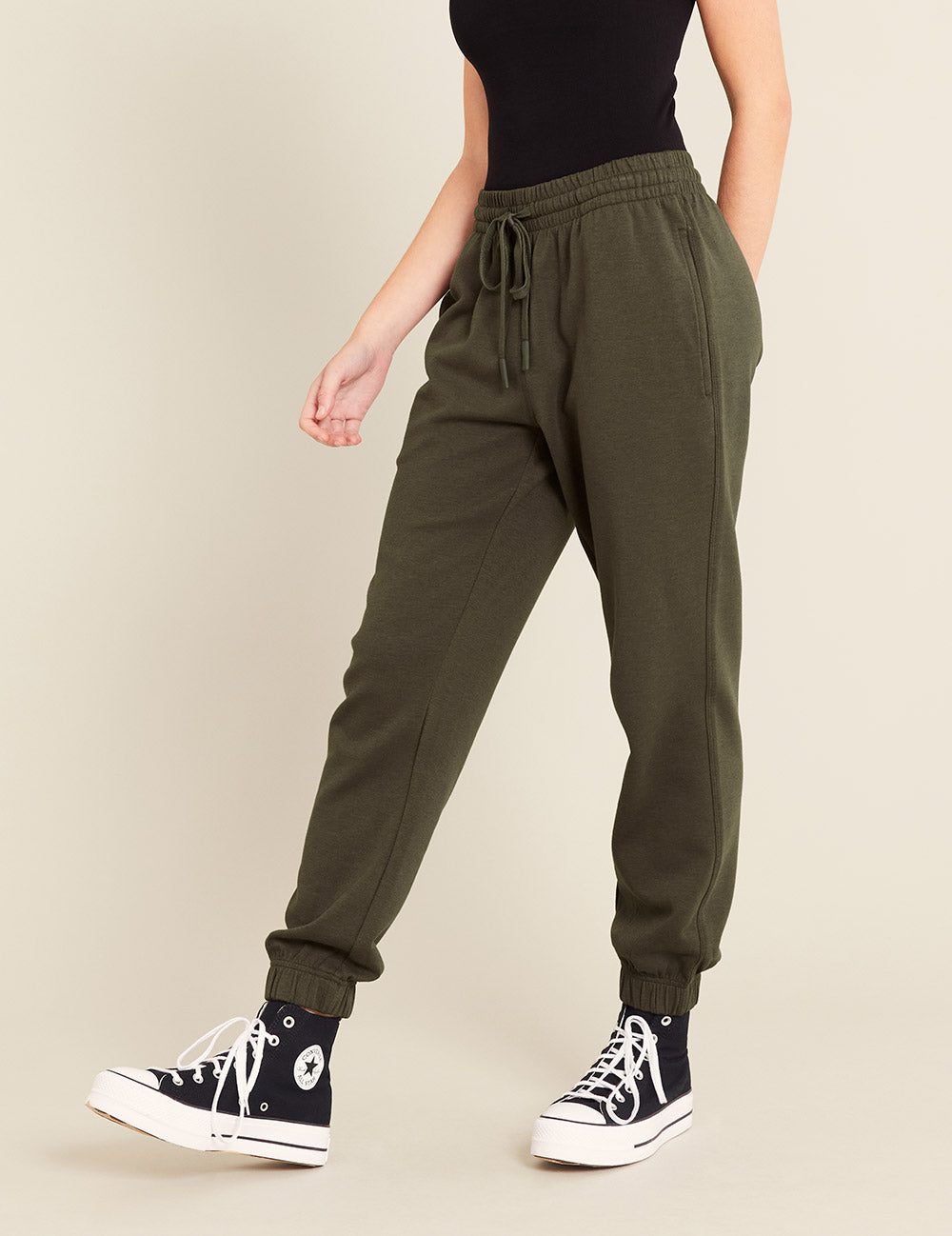 Gender-Neutral-Cuffed-Sweat-Pants-Dark-Olive-Female-Side.jpg